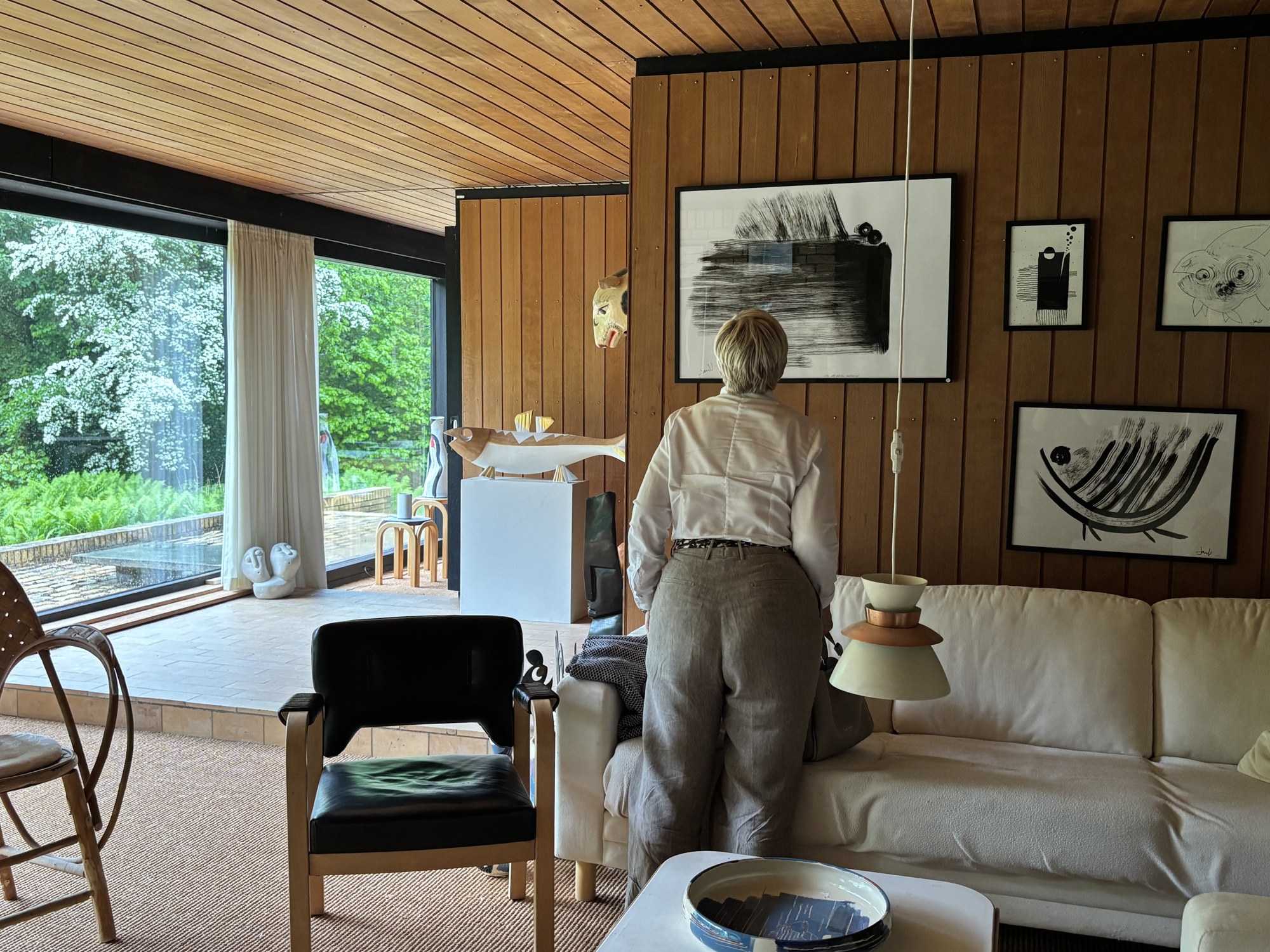 A Copenhagen host in her mid-century living room surrounded by art and personal objects